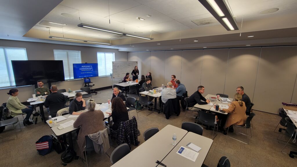  />
<figcaption><em>Conference participants work together in small group sessions to brainstorm economic resilience implementation plans. Photo: Brett Schwartz.</em></figcaption>
</figure>
<!-- /wp:image --></p>
<p><!– wp:heading {” level></p>
<h4>Volatility in the Energy Industry</h4>
<p><!-- /wp:heading --></p>
<p><!-- wp:paragraph --></p>
<p>It’s been difficult for host communities to know when their plant will close or understand how the decommissioning and closure process works. This uncertainty makes it challenging for a community to plan for their long-term economic health and makes planning intimidating- no one wants to think about their plant closing, and public opinion can vary greatly. Often, there is pushback against planning for the future if the public feels that planning for closure will encourage the utility to prematurely shut down a plant.</p>
<p><!-- /wp:paragraph --></p>
<p><!-- wp:heading {