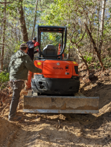The Erwin, TN construction team "breaks ground" on the new mountain bike park, forging a trail through the forest